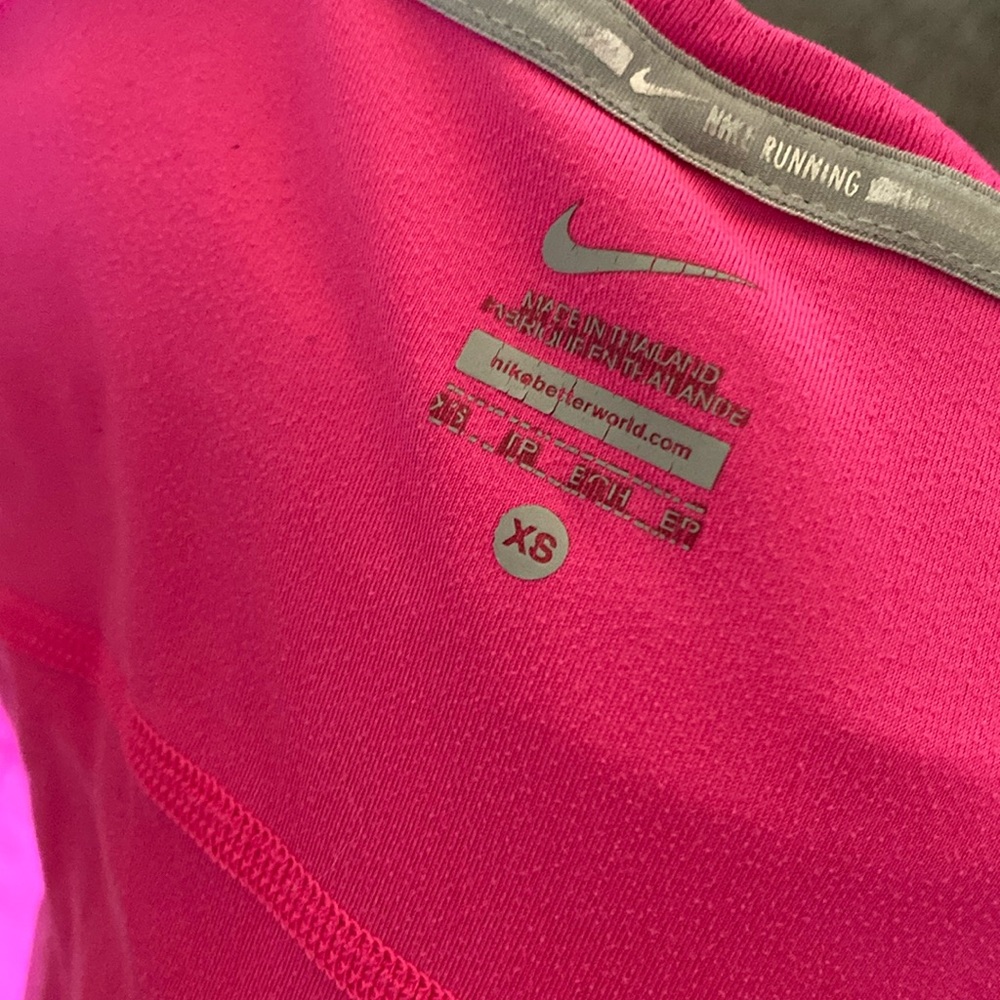 hot pink Nike running shirt.